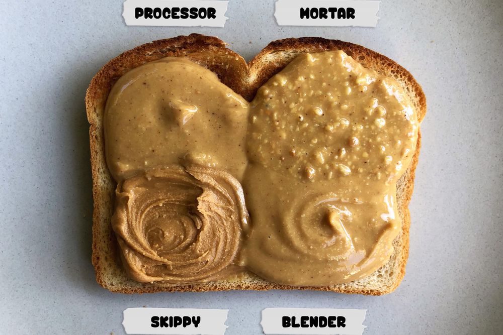 Four different types of peanut butter, labeled processor, mortar, Skippy, and blender, smeared in four contiguous quadrants on one piece of toast.