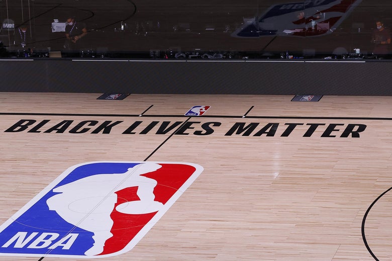 The NBA logo on the court in the bubble, with the Black Lives Matter slogan painted above it.