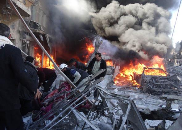Medical personnel look for survivors following a reported airstrike on the Tariq al-Bab district of the northern Syrian city of Aleppo on February 1, 2014.