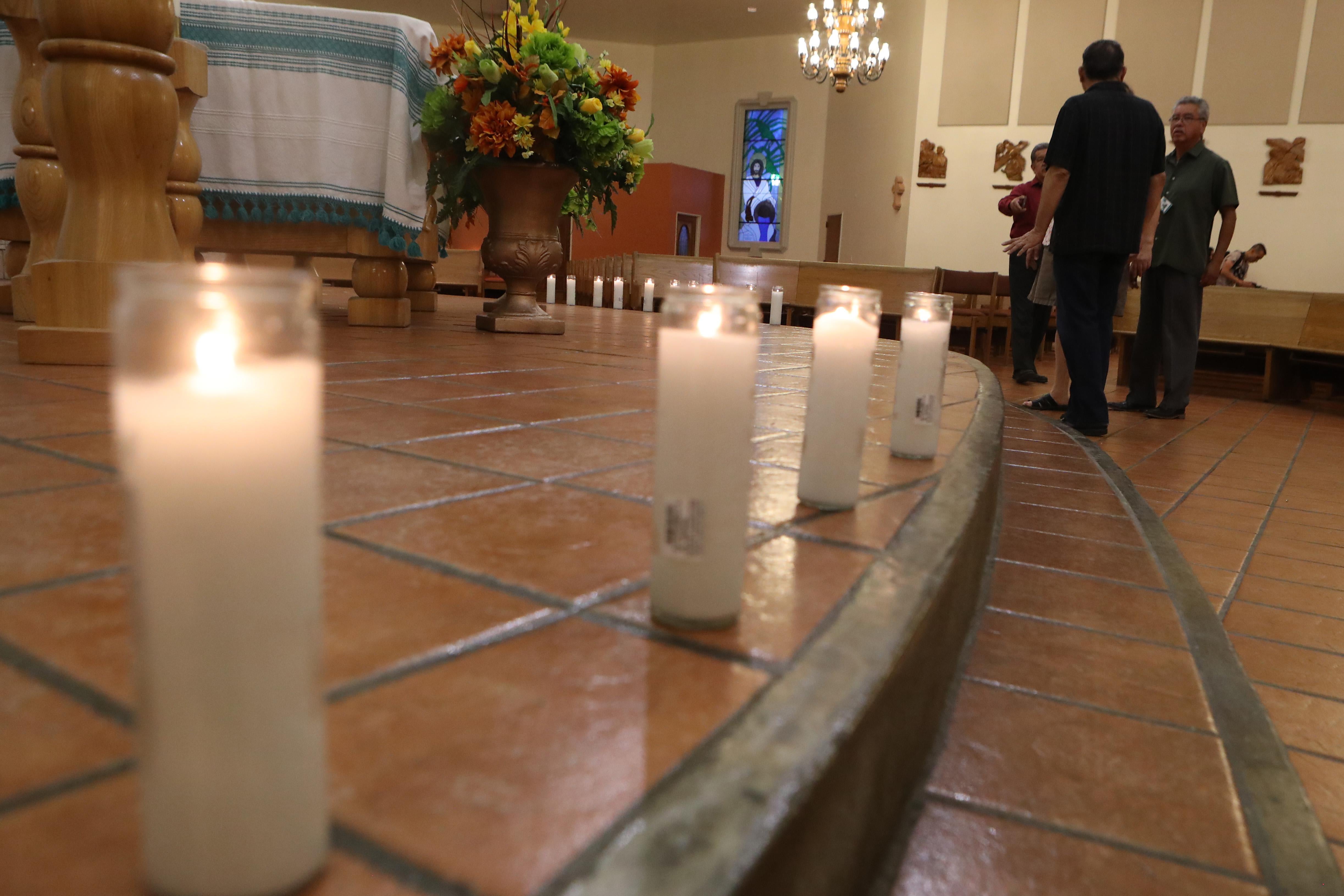 A row of candles on the floor of the church.