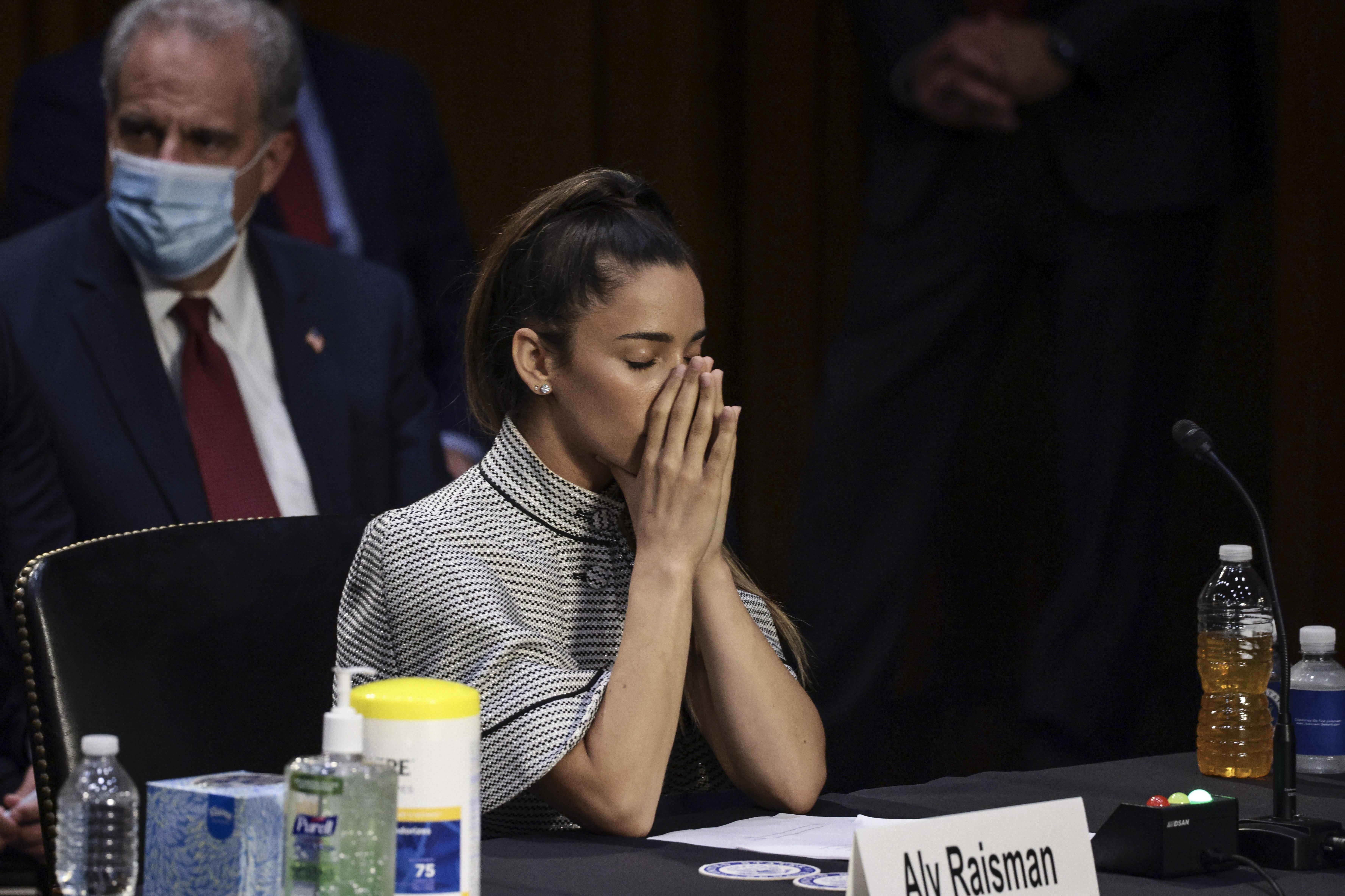 WASHINGTON, DC - SEPTEMBER 15: U.S. Olympic Gymnast Aly Raisman closes her eyes as U.S. Olympic Gymnast McKayla Maroney gives testimony during a Senate Judiciary hearing about the Inspector General's report on the FBI handling of the Larry Nassar investigation of sexual abuse of Olympic gymnasts, on Capitol Hill on September 15, 2021 in Washington, DC. Raisman and other fellow U.S. Gymnasts gave testimony on the abuse they experienced at the hand of Larry Nassar, the former US women's national gymnastics team doctor, and the FBI’s lack of urgency when handling their cases. (Photo by Anna Moneymaker/Getty Images)