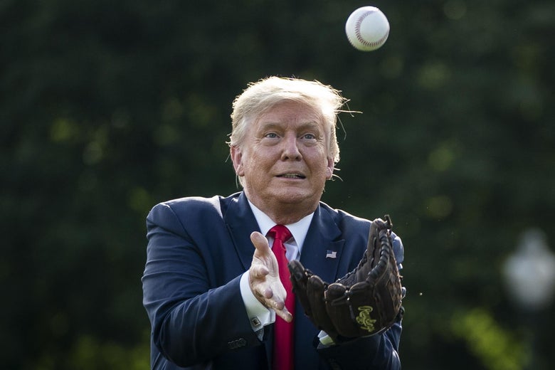 Then-President Donald Trump catches a baseball thrown by former New York Yankees Hall of Fame pitcher Mariano Rivera on the South Lawn of the White House on July 23, 2020 in Washington, D.C.