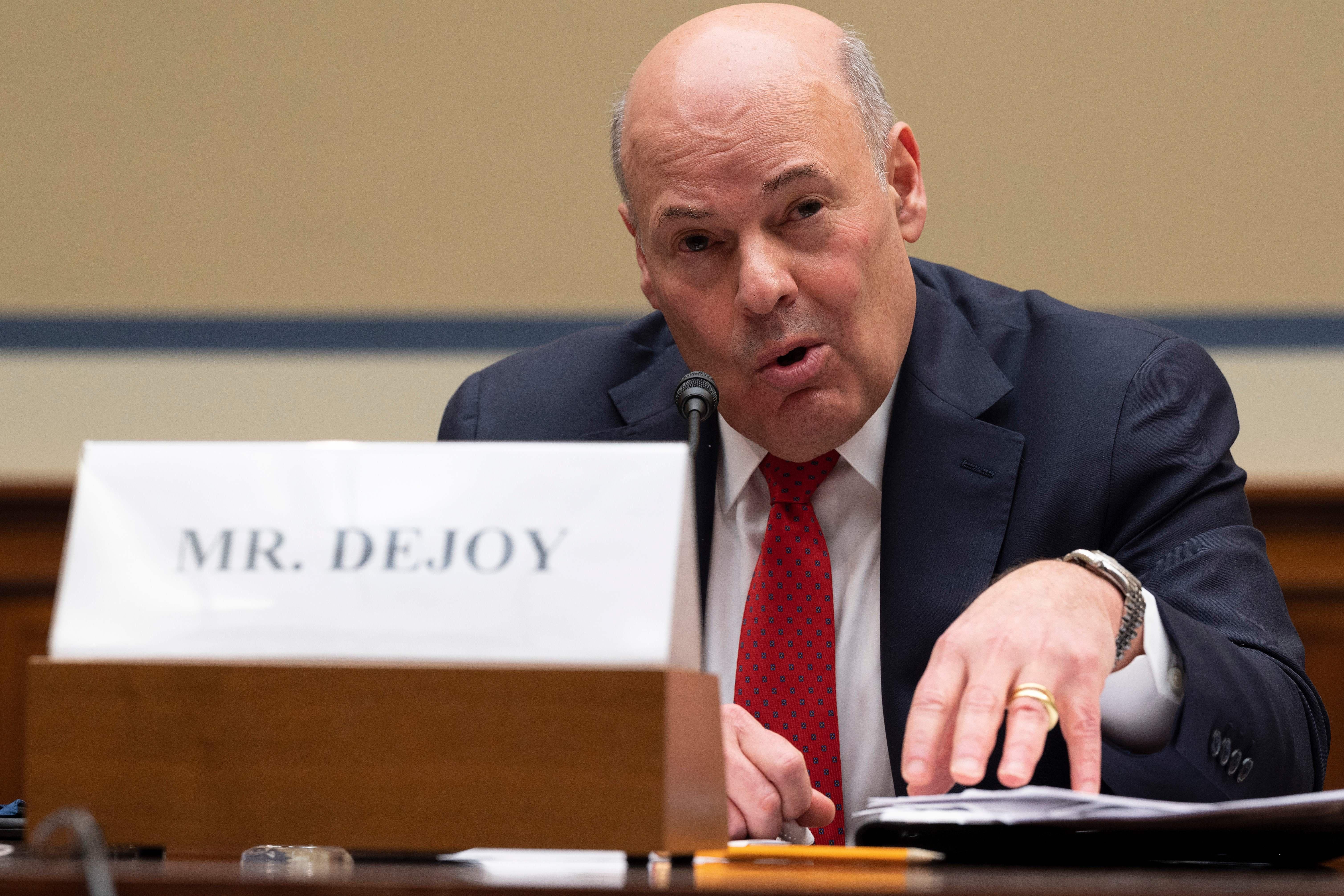 Louis DeJoy speaks while seated in a congressional hearing.