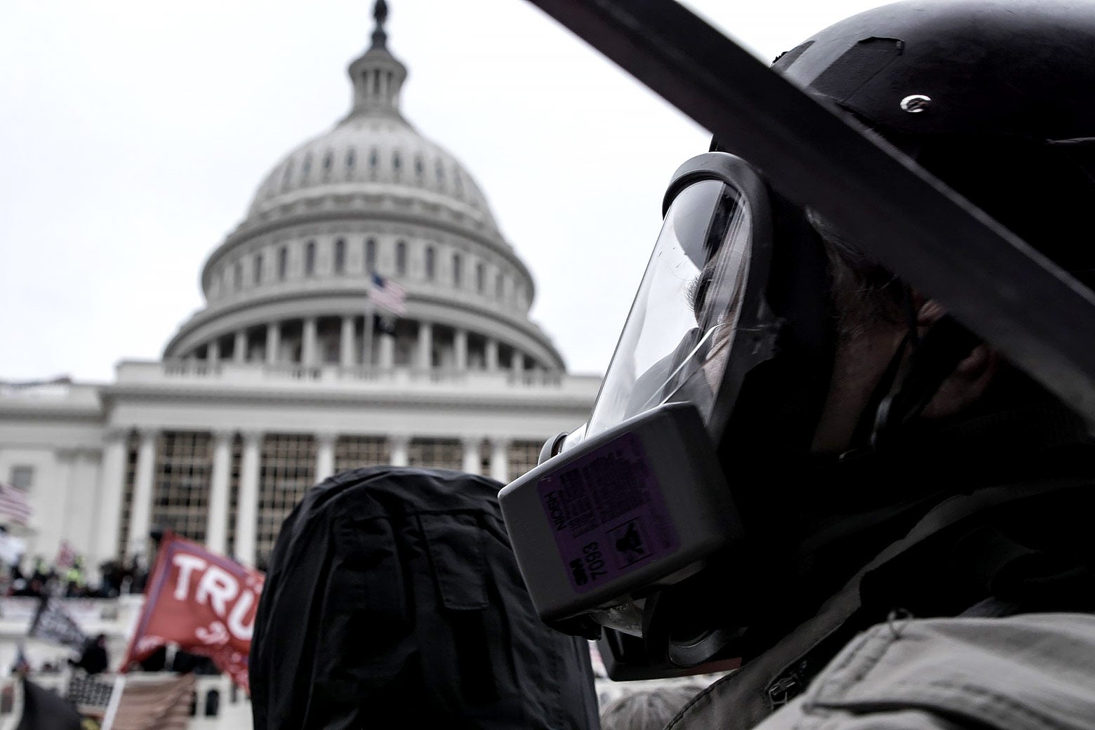 A still from the documentary The Sixth of a person wearing riot gear in front of the U.S. Capitol on Jan. 6, 2021.