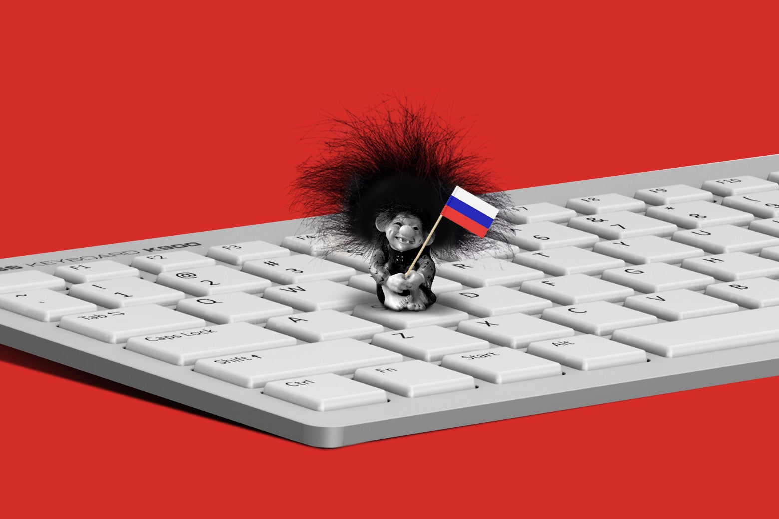 A Troll doll holding a Russian flag while standing on a keyboard.